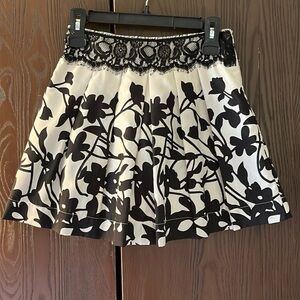 Miroa  cream and black, mini skirt. Looks silky. Size Small.